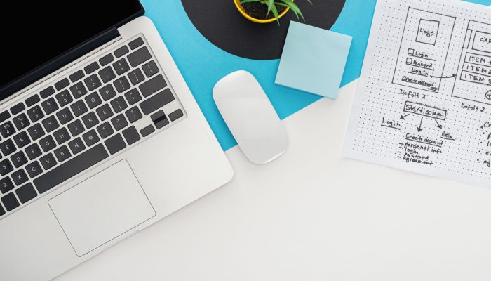 top view of laptop, computer mouse, plant, website design template on abstract geometric background top view of laptop, computer mouse, plant, website design template on abstract geometric background